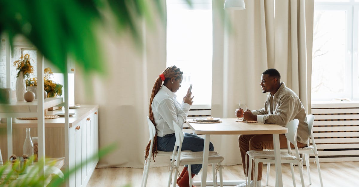 African couple dining together in a modern kitchen, capturing moments over breakfast.