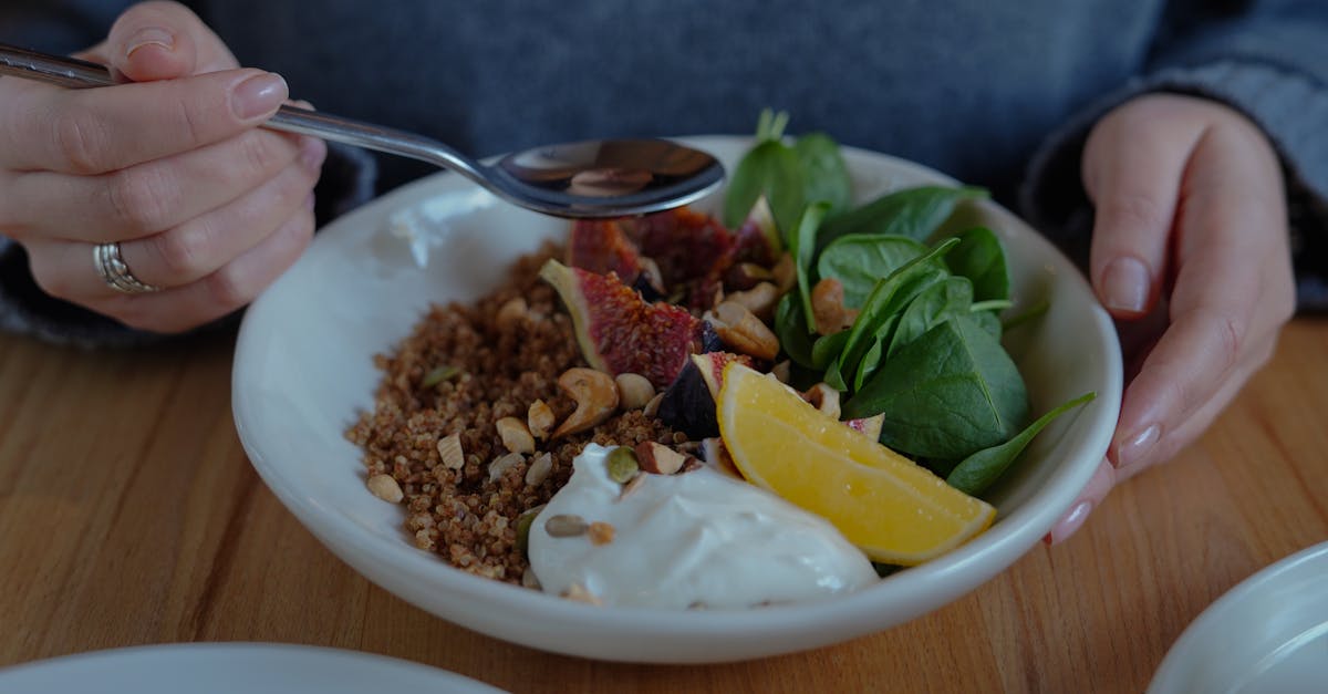 A vibrant brunch bowl with fruit, greens, and nuts for a nutritious meal.